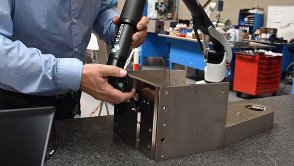 An image capturing a technician using an Absolute Arm scanner