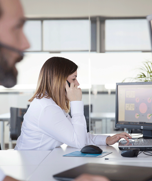 A support agent at their desk speaking on the telephone