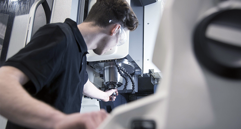Service and support engineer working on a machine