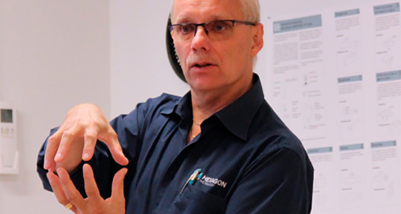 man presenting making a shape with his hands