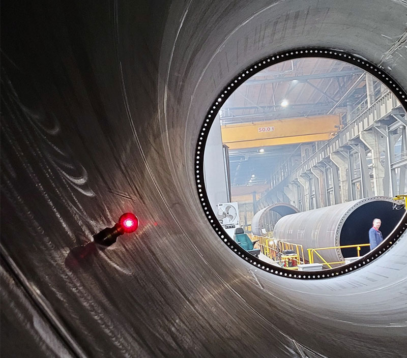 Laser tracker target inside a large industrial cylinder, capturing precise measurements for alignment and inspection in manufacturing