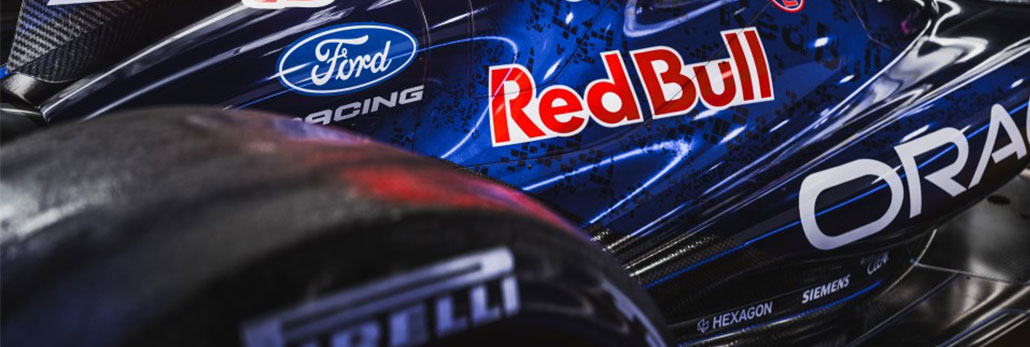 A close up for Oracle Red Bull Racing's RB22 with a tyre in the foreground and sponsor logos on the car body