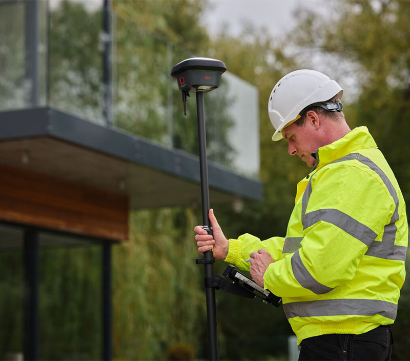 surveyor measures points and captures images of a residence with a smart antenna and controller
