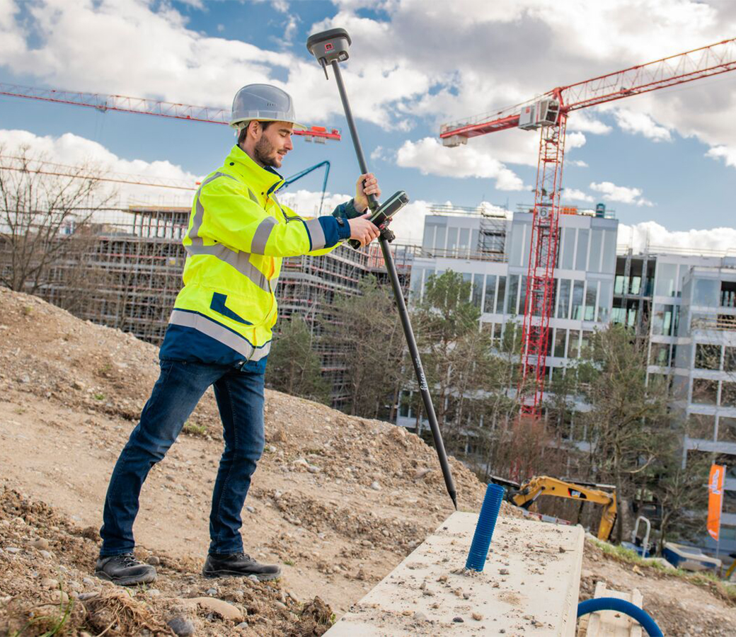 surveyor measures a point on a building construction site