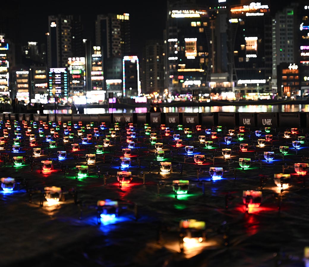 Rows of drones with colorful lights 