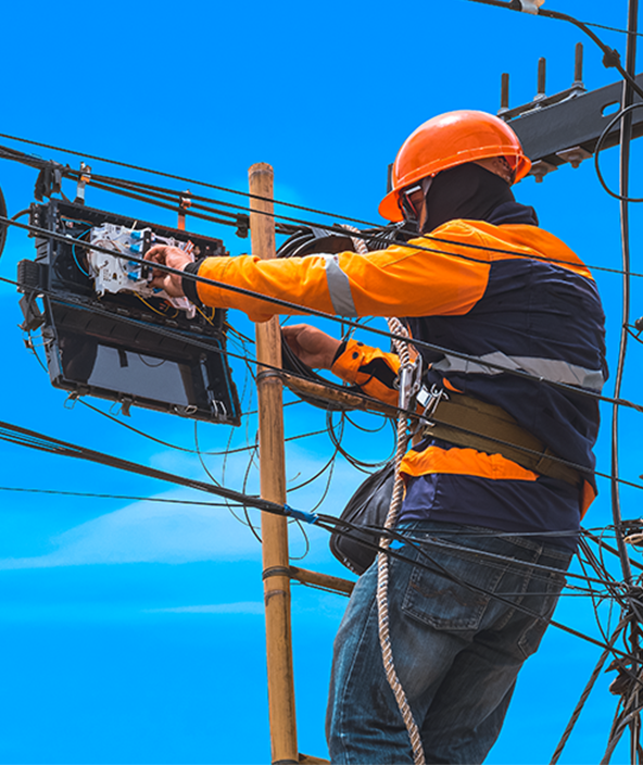 Utility worker servicing fiber optic cable