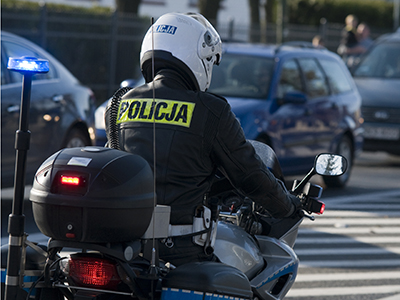 Police officer patrols on a motor bike