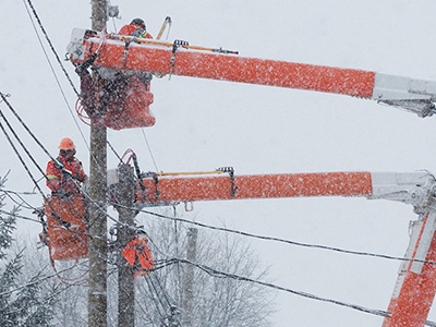 Electric workers work to restore power