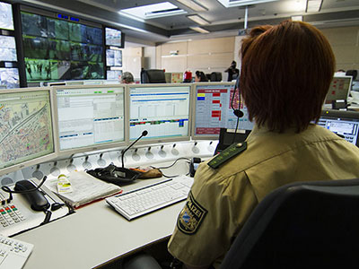 Image of a police officer sitting in a control room