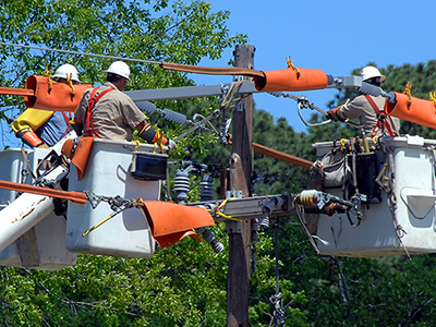 Maintenance workers repair damaged power line