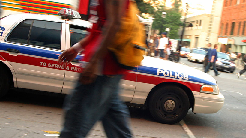 A police car speeds towards a crime in urban Toronto