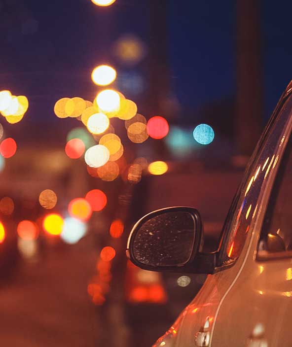 Car in city traffic at night