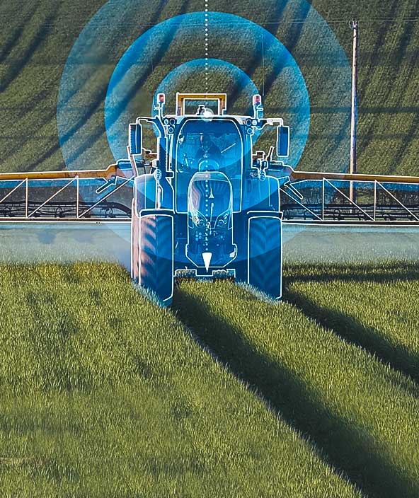 A farmer spraying fertilizer on his crops