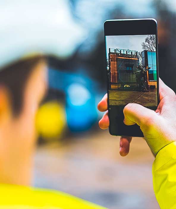 man taking images of a construction site on a smart phone