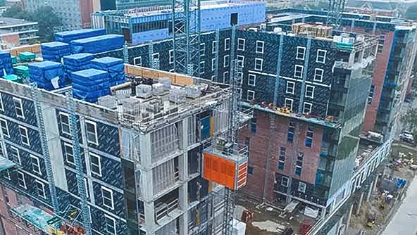 An image of a building under construction, highlighted by a crane, representing the importance of documentation and verification solutions.