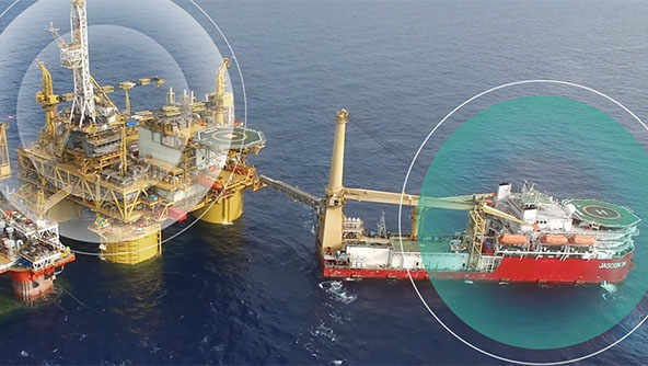 An oil rig highlighted by a large green circle, showcasing GNSS visualization software capabilities.