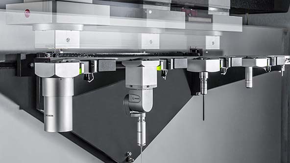 Image of a Coordinate Measuring Machine (CMM) featuring a variety of sensors, probes, and styli changers, indicating versatile capabilities.