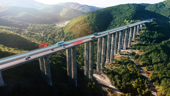 Photo of vehicles driving over long bridge